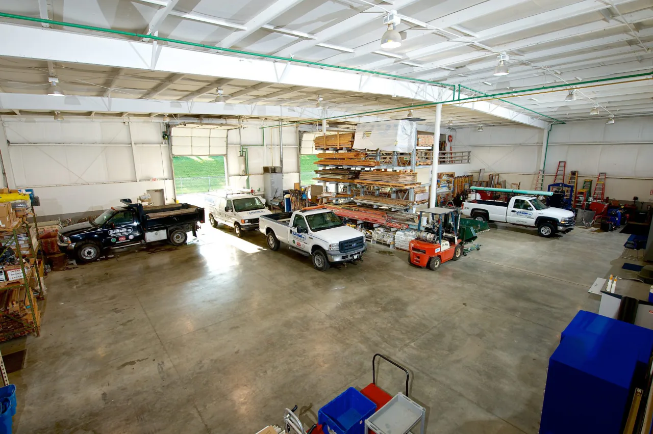 Inside the Bob Frame Plumbing shop with service trucks and material racks