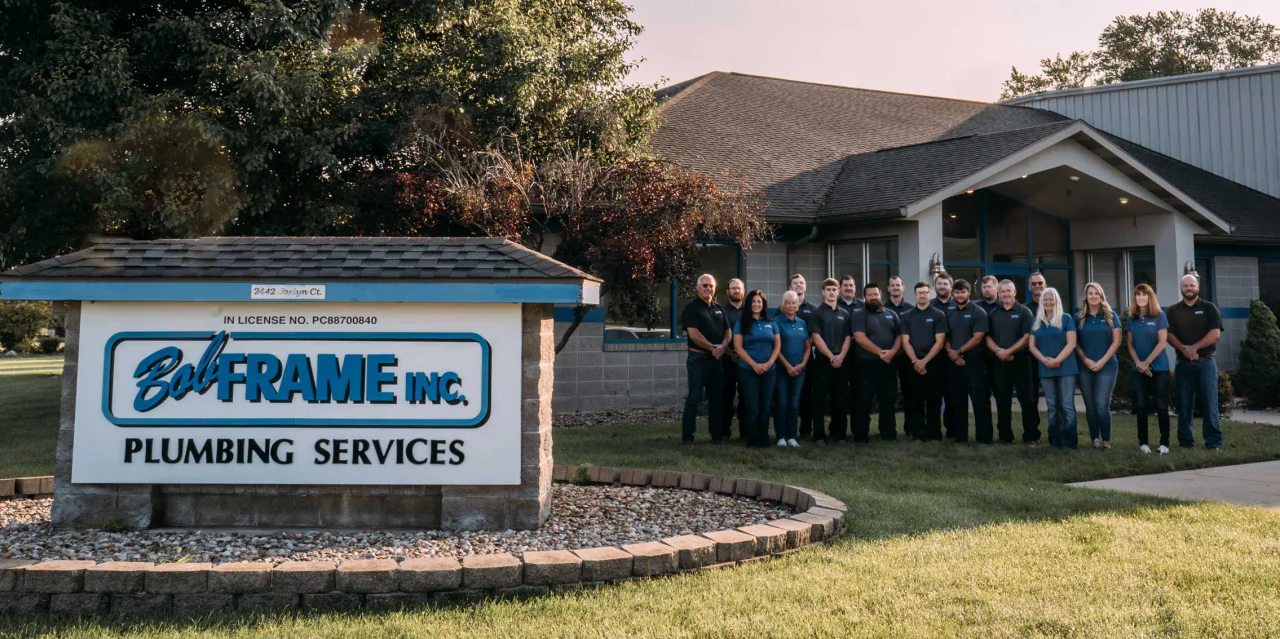 The Bob Frame Plumbing team in front of the company sign at 2442 Jaclyn Court