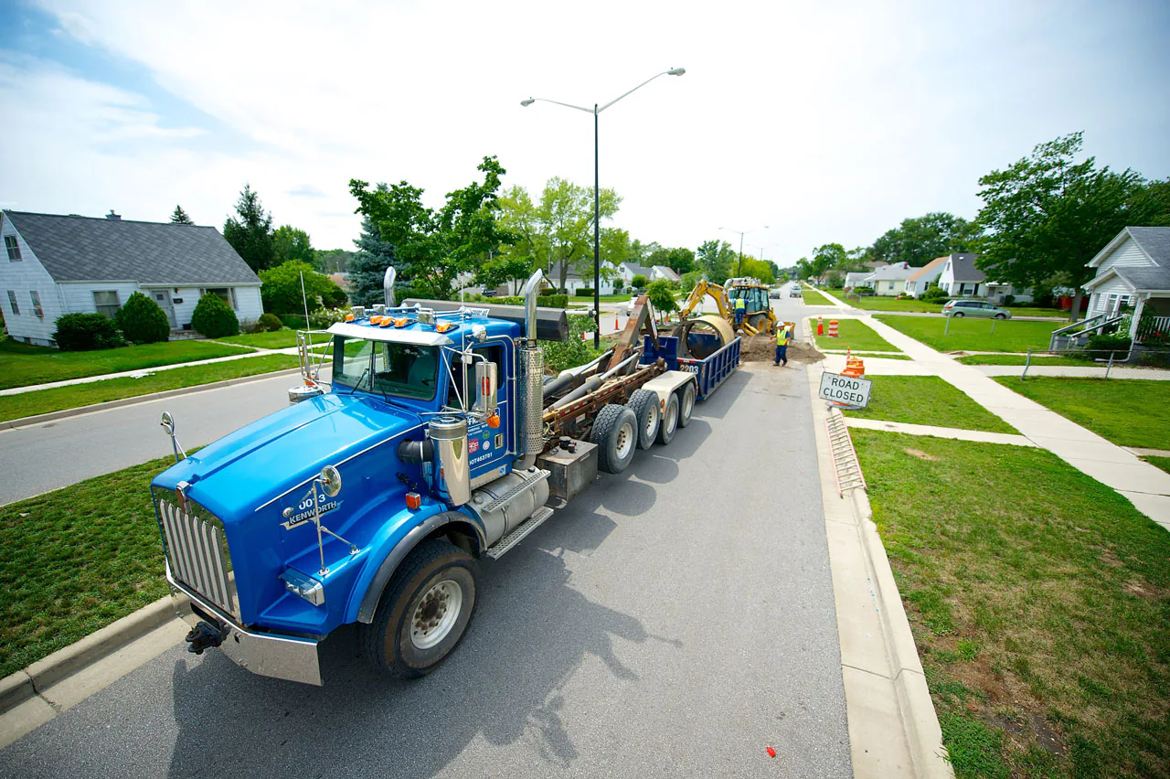 A Bob Frame Plumbing vac truck on a residential street